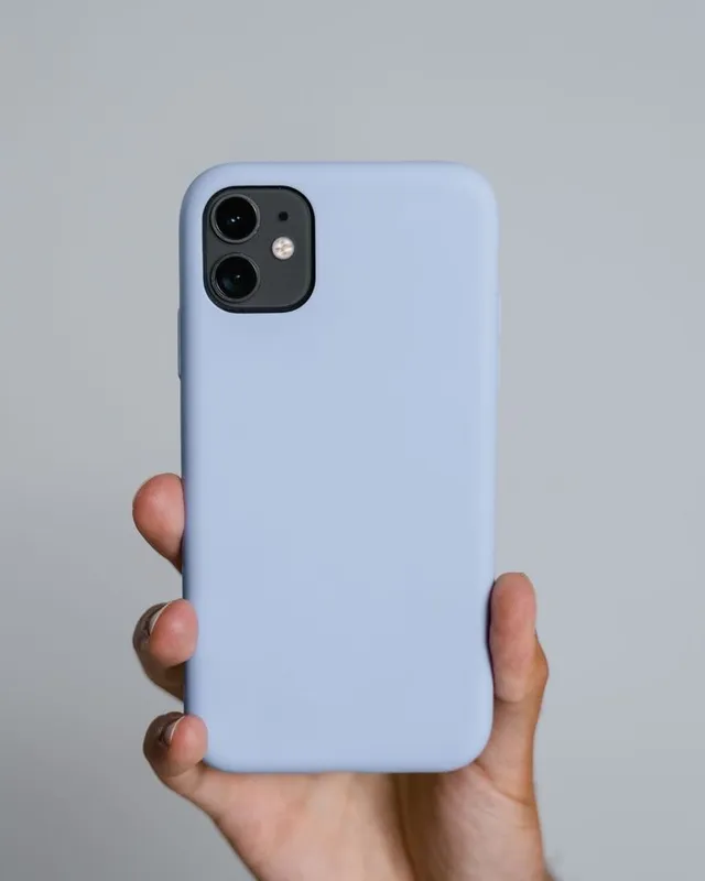 Hand hält ein Smartphone in einer Silikonhülle